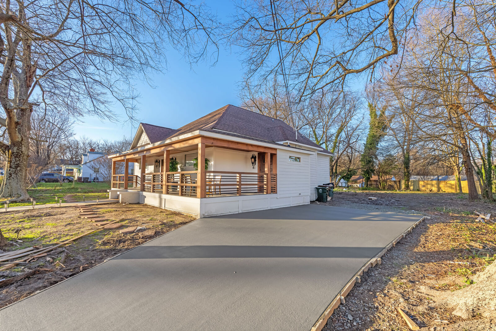 A small porch-front building beside a new smooth concrete driveway
