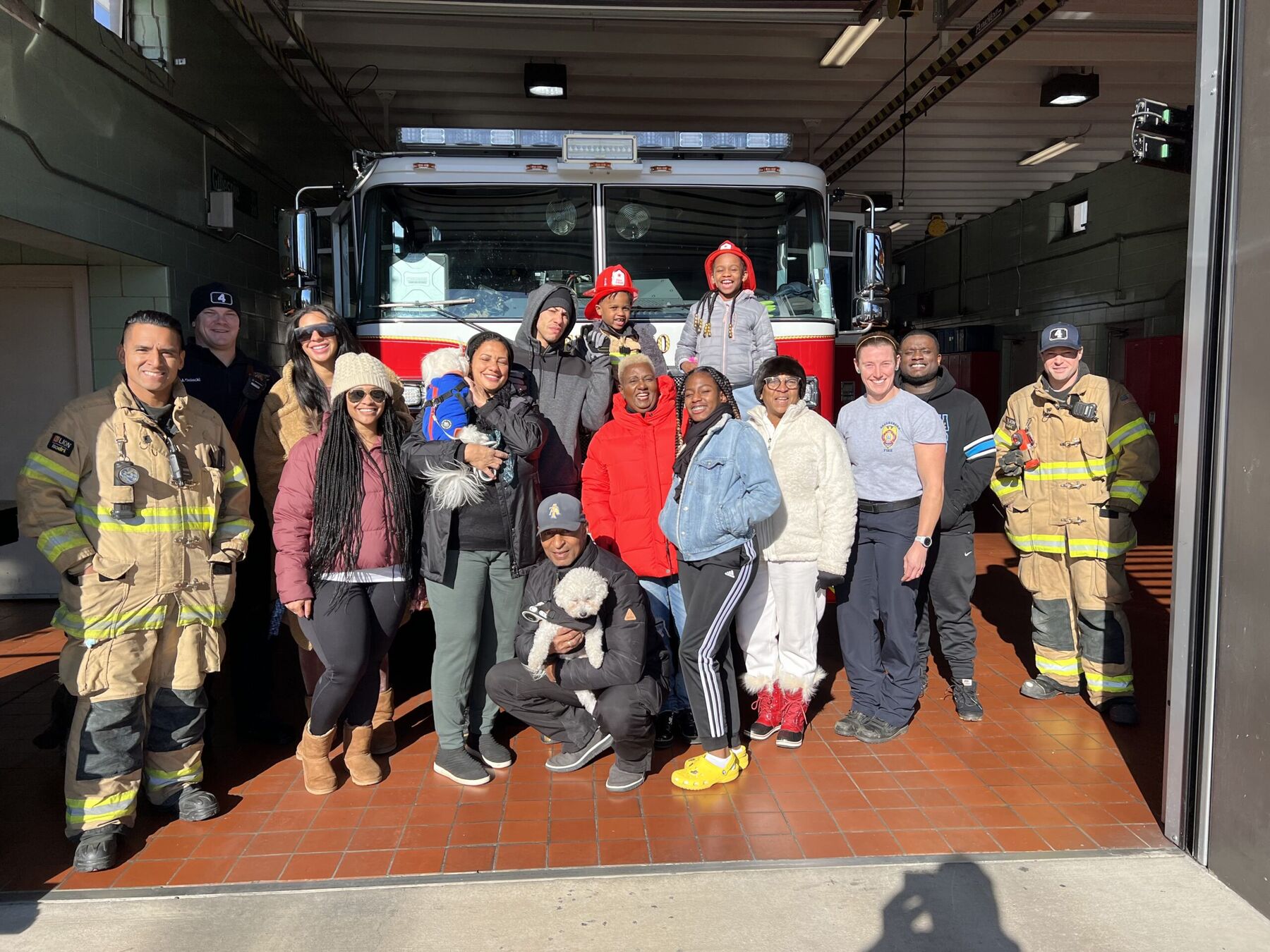 Neighbors and firefighters gathered in front of a Greensboro fire truck
